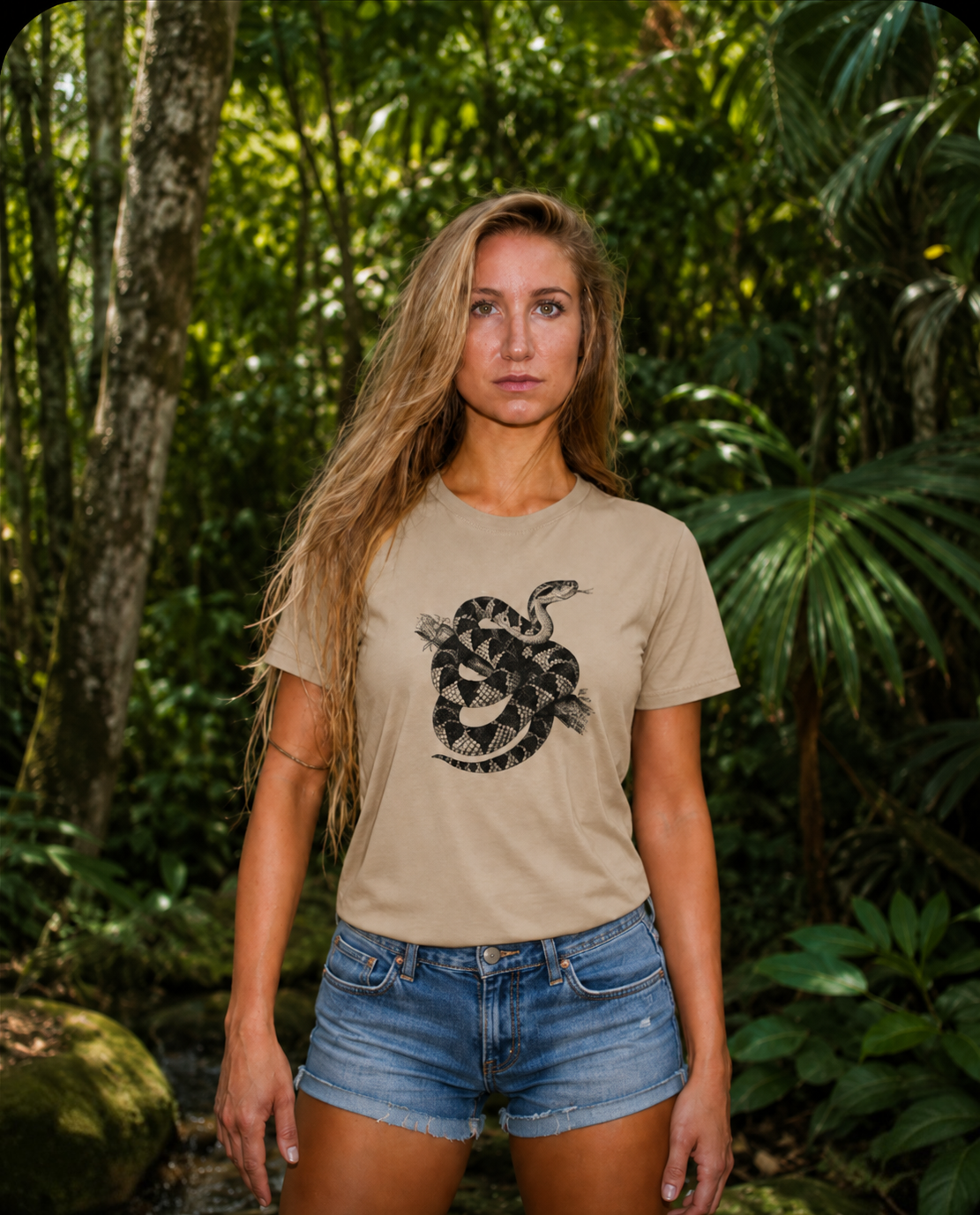 Harmonie wearing the Son of Nature Surucucu bushmaster tee in khaki, charcoal bushmaster coiled on a branch on the chest, in a lush Kauai jungle